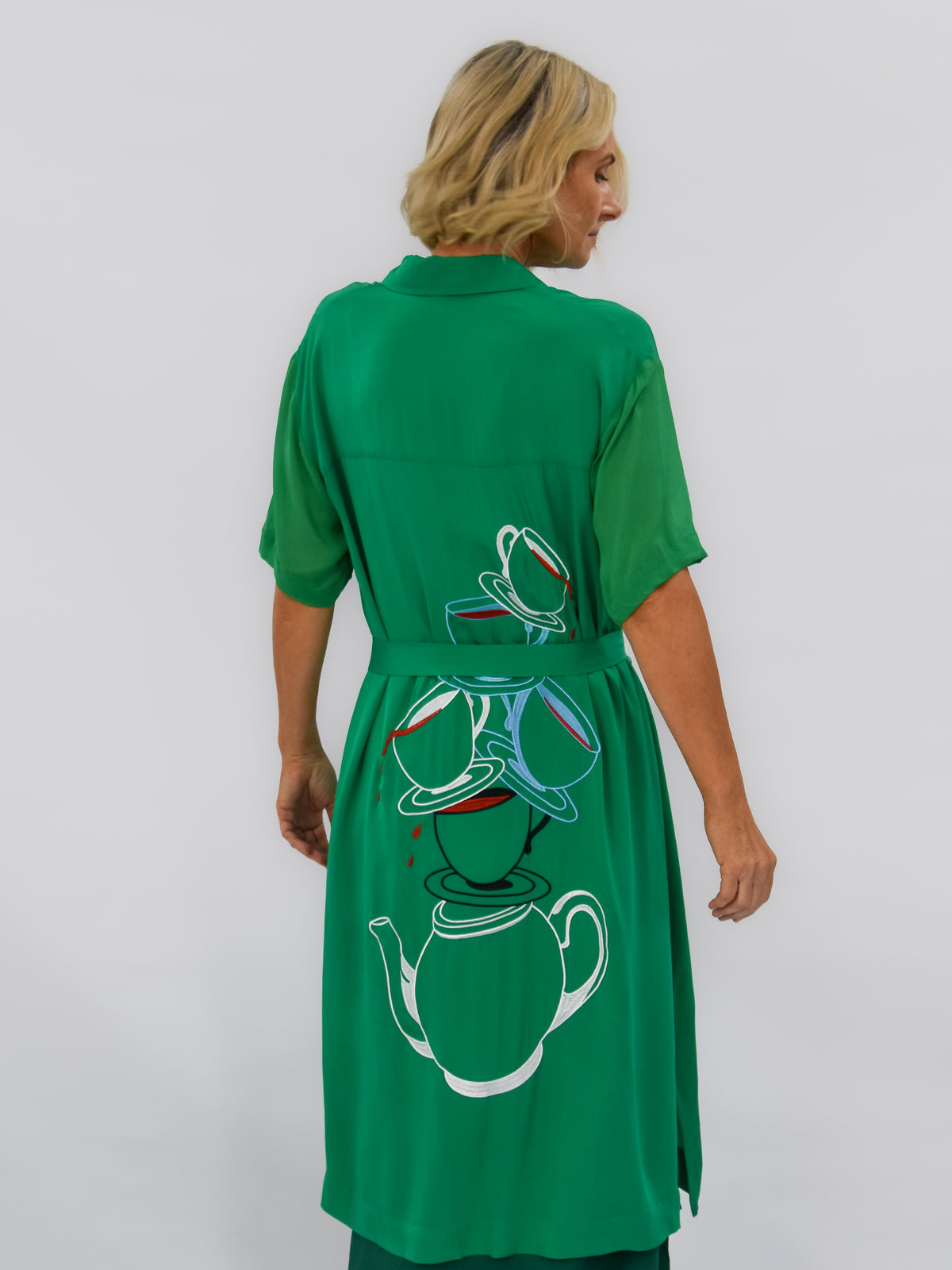 Green short sleeve dress with tea cups on back tied waist - back view 