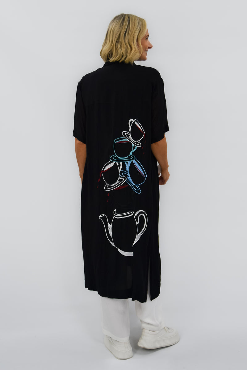 Black short sleeve dress with tea cups and tea pot cascading down the back down the back 